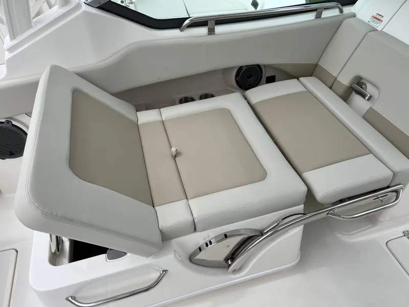 Slide: The Image of 2025 Boston Whaler 240 Vantage boat interior seating with beige and white upholstery. - 23