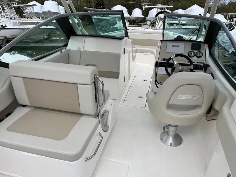 Slide: The Image of 2025 Boston Whaler 240 Vantage boat interior with seating and steering console. - 24