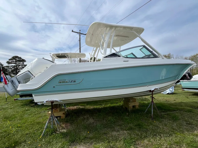 Slide: The Image of 2025 Boston Whaler 240 Vantage boat displayed on grass, side view. - 32