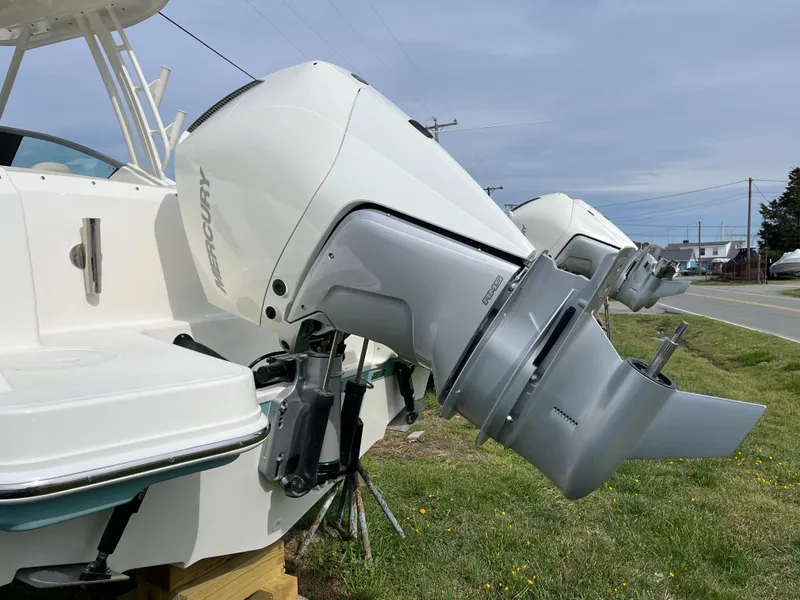 Slide: The Image of 2025 Boston Whaler 240 Vantage with dual Mercury outboard engines, parked on grass. - 35