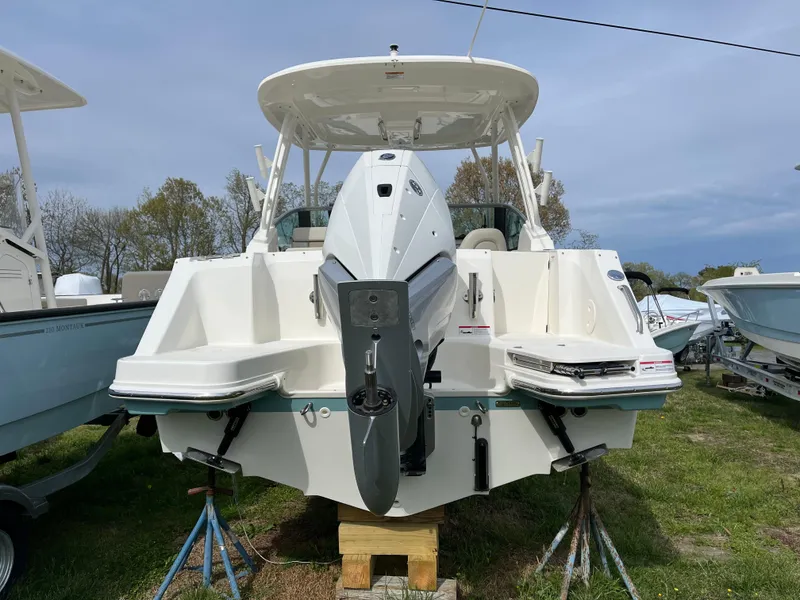 Slide: The Image of 2025 Boston Whaler 240 Vantage boat, rear view, on display outdoors. - 36