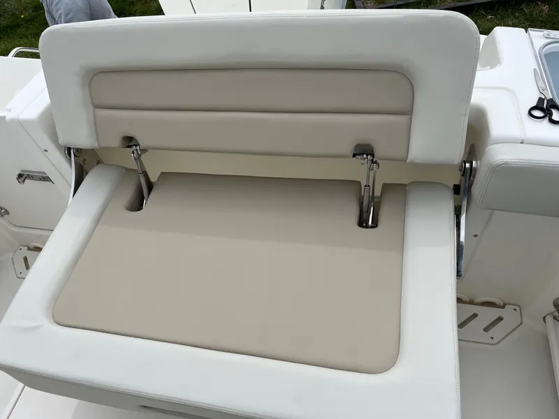 Slide: The Image of 2025 Boston Whaler 240 Vantage boat seat with beige and white upholstery. - 7