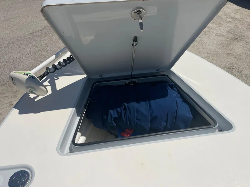 Slide: The Image of Open storage compartment on 2019 Maverick Mirage 18 HPX-V boat, showing interior contents. - 14