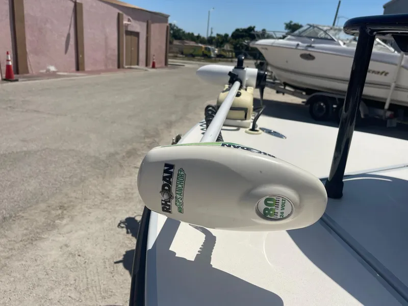 Slide: The Image of 2019 Maverick Mirage 18 HPX-V with Rodan trolling motor in a boatyard setting. - 15