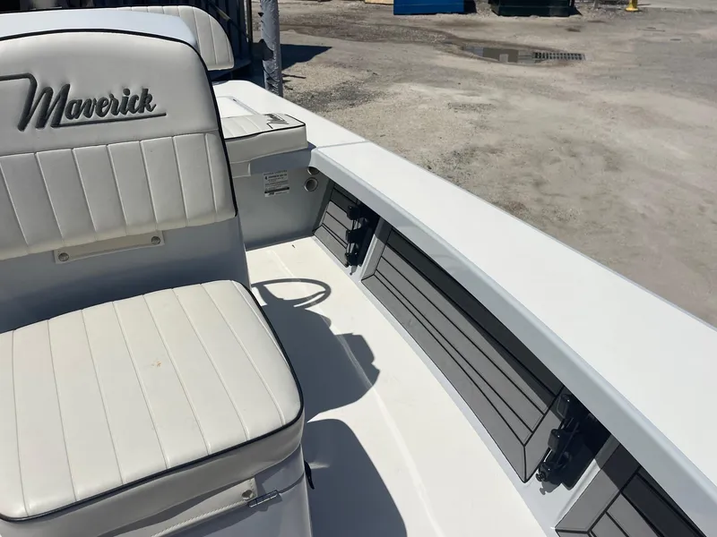 Slide: The Image of 2019 Maverick Mirage 18 HPX-V boat interior with white seating and storage compartments. - 17