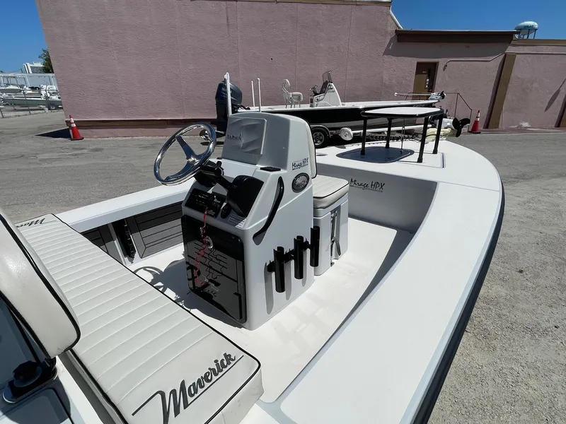 Slide: The Image of 2019 Maverick Mirage 18 HPX-V boat, white interior, steering console, parked outdoors. - 5