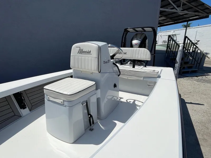 Slide: The Image of 2019 Maverick Mirage 18 HPX-V boat with white seating and console, parked outdoors. - 7