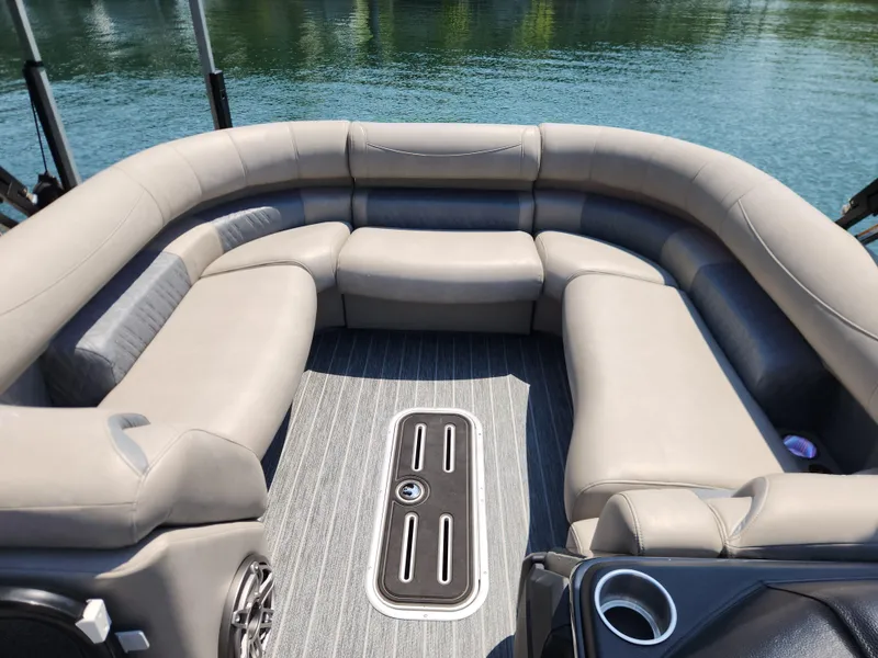Slide: The Image of Luxurious seating on 2023 Premier 250 Intrigue RL pontoon boat, overlooking serene water. - 18