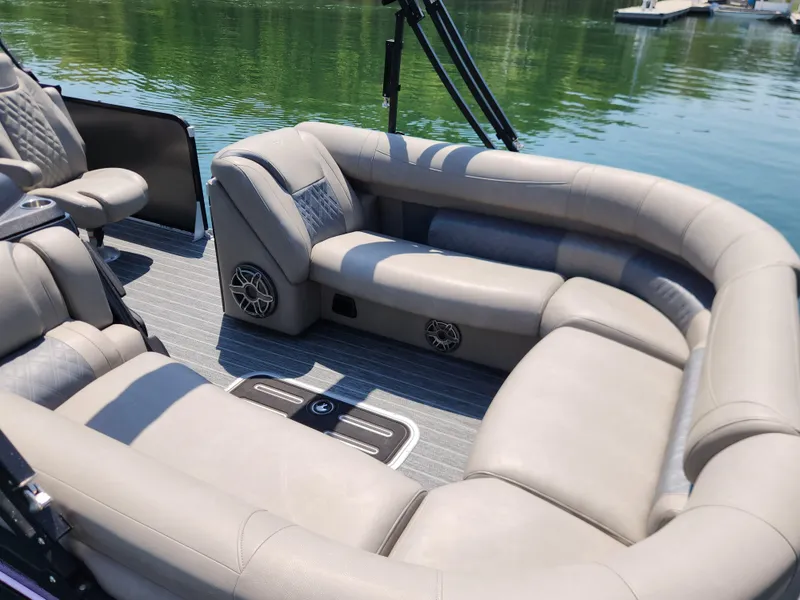 Slide: The Image of Luxurious seating on 2023 Premier 250 Intrigue RL pontoon boat, with plush upholstery and scenic lake view. - 5