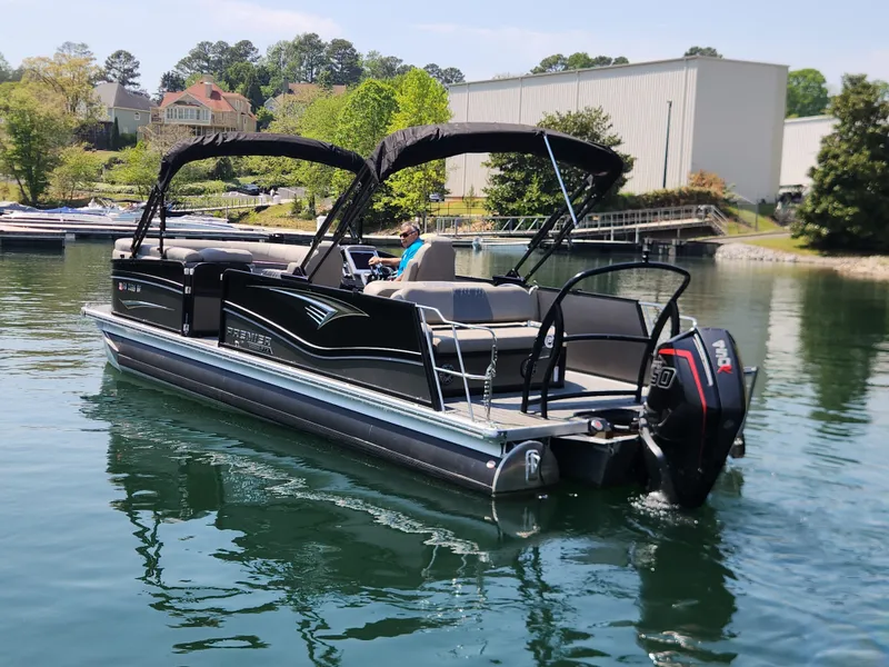 Slide: The Image of 2023 Premier 250 Intrigue RL pontoon boat on a calm lake. - 9