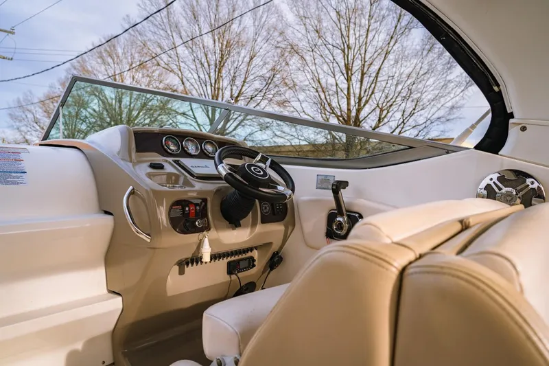 Slide: The Image of 2018 Chaparral 270 Signature boat interior with steering wheel and dashboard controls. - 2
