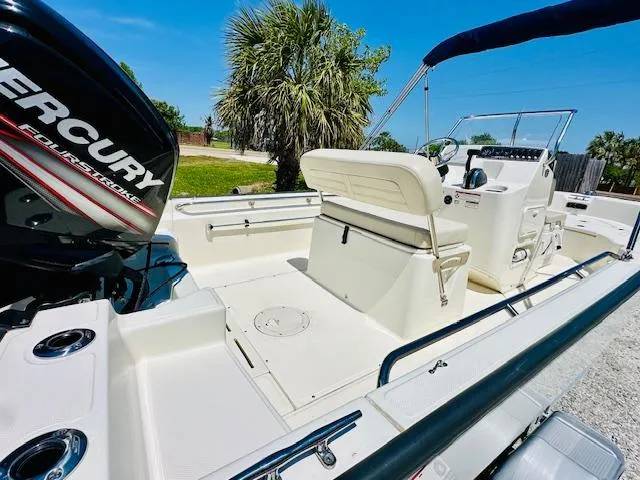 Slide: The Image of 2018 Boston Whaler 170 Montauk boat with Mercury engine, sunny day, palm trees in background. - 10