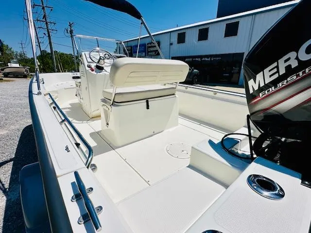 Slide: The Image of 2018 Boston Whaler 170 Montauk boat with Mercury engine, white interior, and outdoor setting. - 11