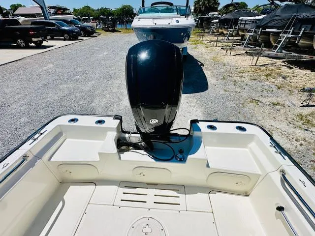 Slide: The Image of 2018 Boston Whaler 170 Montauk boat with outboard motor, parked in a marina. - 15