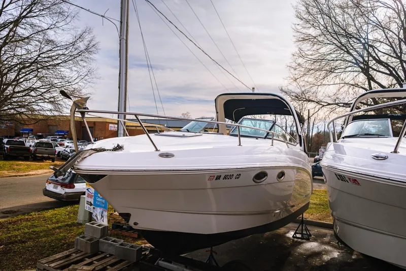 Slide: The Image of 2018 Chaparral 270 Signature boat displayed outdoors on a sunny day. - 0