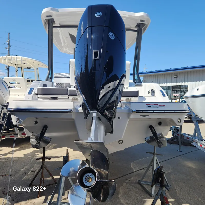 Slide: The Image of 2025 Monterey Elite 27 OB boat with powerful outboard motor, displayed outdoors. - 3