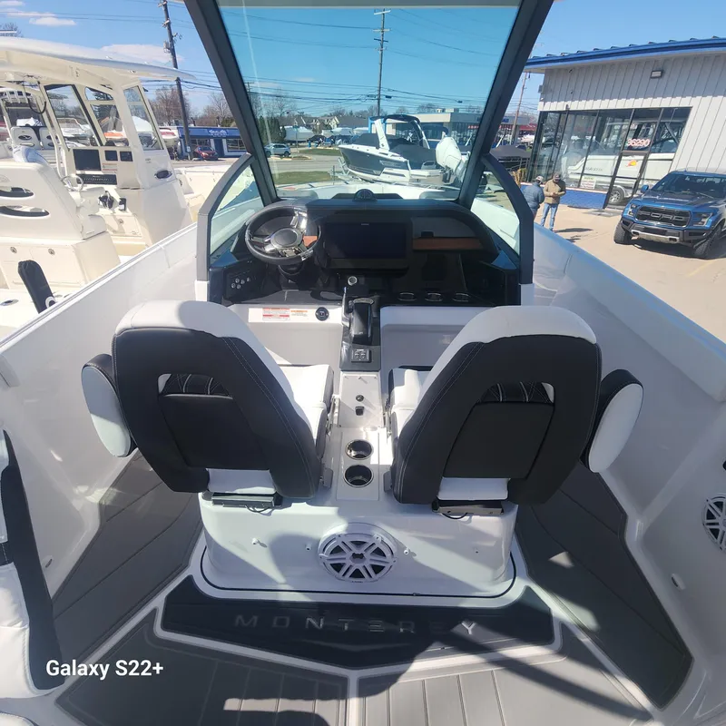 Slide: The Image of 2025 Monterey Elite 27 OB boat interior with dual seats and modern dashboard. - 5