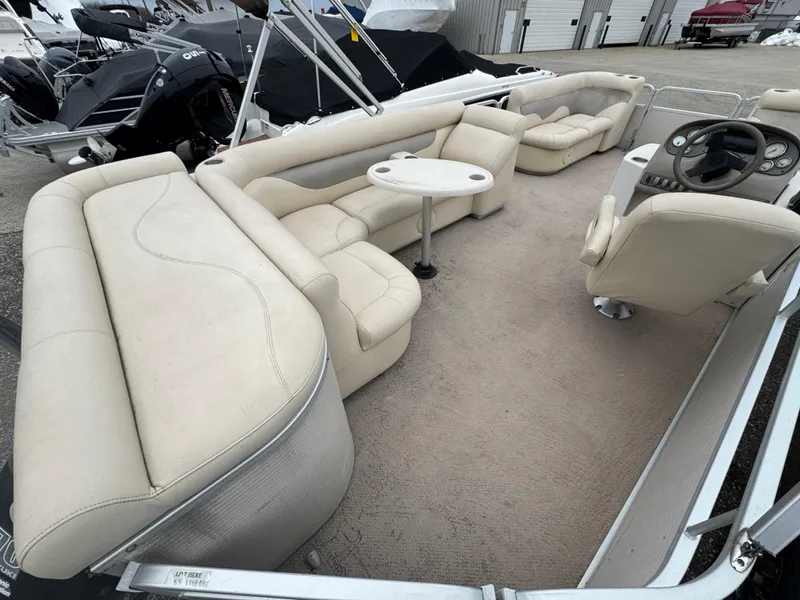 Slide: The Image of 2007 Premier 210 SunSation RE pontoon boat with beige seating and steering console. - 6
