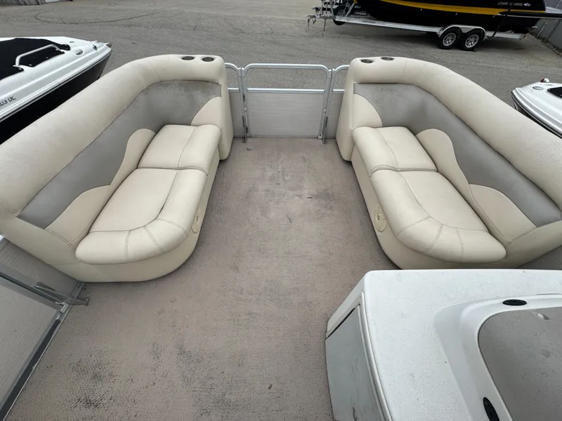 Slide: The Image of 2007 Premier 210 SunSation RE pontoon boat with beige seating and spacious deck layout. - 8