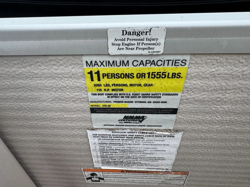 Slide: The Image of 2007 Premier 210 SunSation RE capacity label: 11 persons or 1555 lbs, safety warnings included. - 9
