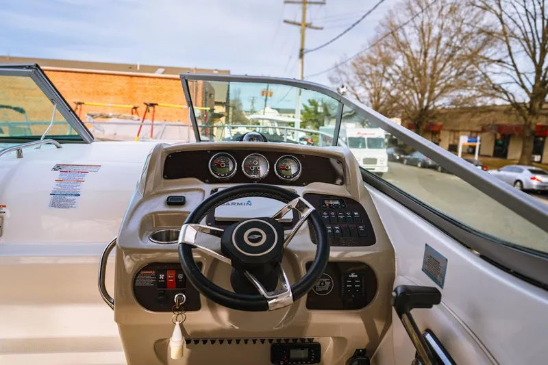 Slide: The Image of Cockpit view of 2018 Chaparral 270 Signature boat with steering wheel and dashboard controls. - 3