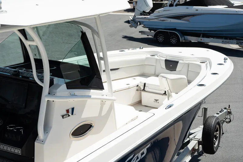 Slide: The Image of 2018 Wellcraft 302 Fisherman boat on trailer, featuring spacious seating and modern design. - 10