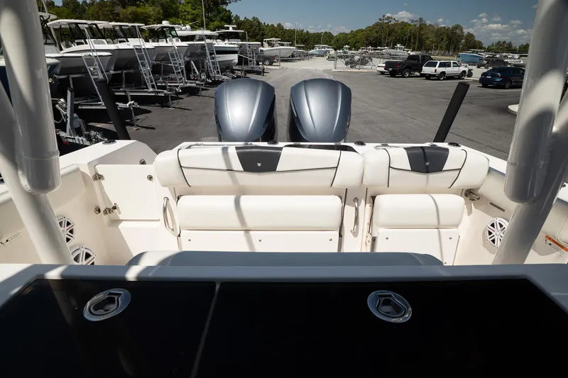 Slide: The Image of 2018 Wellcraft 302 Fisherman boat with dual engines, parked in a marina. - 12