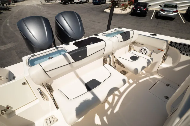 Slide: The Image of 2018 Wellcraft 302 Fisherman boat interior with seating and dual outboard engines. - 16