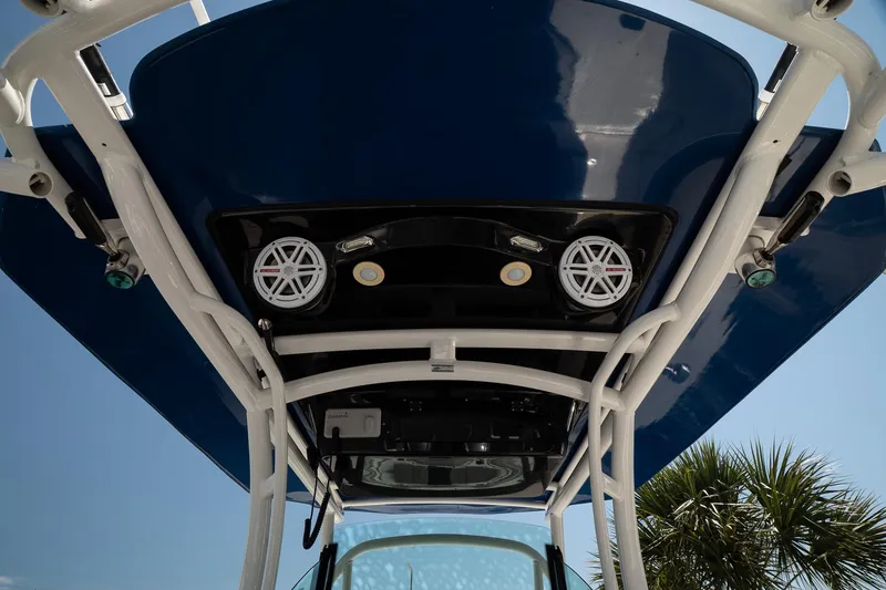 Slide: The Image of 2018 Wellcraft 302 Fisherman boat's overhead view with speakers and blue canopy. - 20