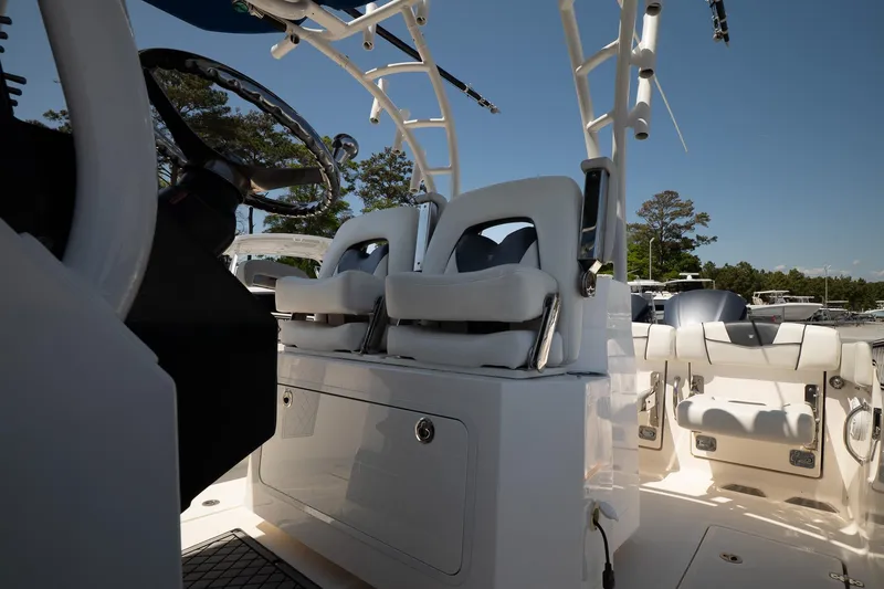 Slide: The Image of 2018 Wellcraft 302 Fisherman boat interior with dual seats and steering wheel. - 21