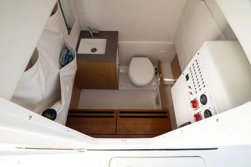 Slide: The Image of 2018 Wellcraft 302 Fisherman boat interior with sink, toilet, and control panel. - 23