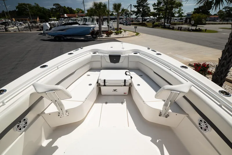 Slide: The Image of 2018 Wellcraft 302 Fisherman boat interior with seating and storage, docked at a marina. - 26