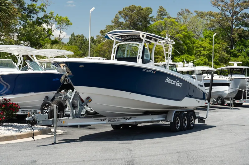 Slide: The Image of 2018 Wellcraft 302 Fisherman boat on trailer, parked outdoors in a marina setting. - 3