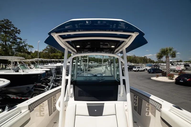 Slide: The Image of 2018 Wellcraft 302 Fisherman boat with T-top, docked in a marina under clear skies. - 30