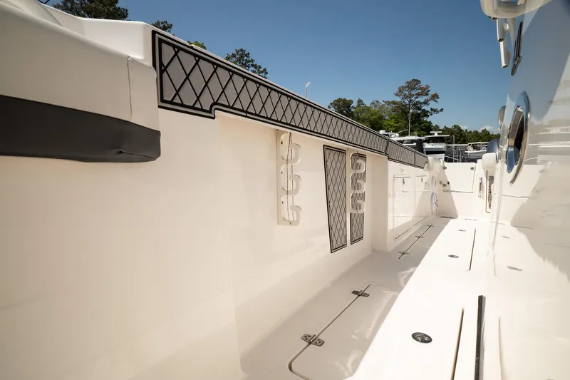 Slide: The Image of 2018 Wellcraft 302 Fisherman boat deck with storage compartments and rod holders. - 31