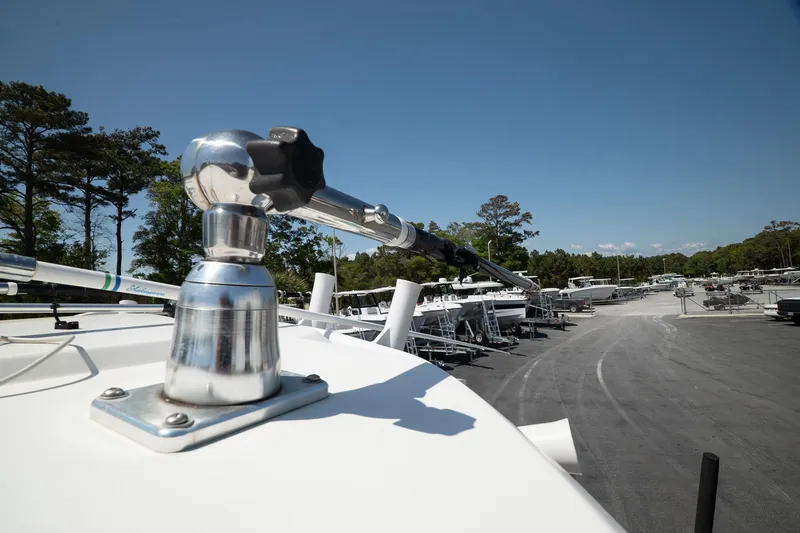 Slide: The Image of 2018 Wellcraft 302 Fisherman boat detail with marina background and clear blue sky. - 33