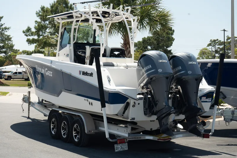 Slide: The Image of 2018 Wellcraft 302 Fisherman boat with dual Yamaha engines on a trailer. - 6