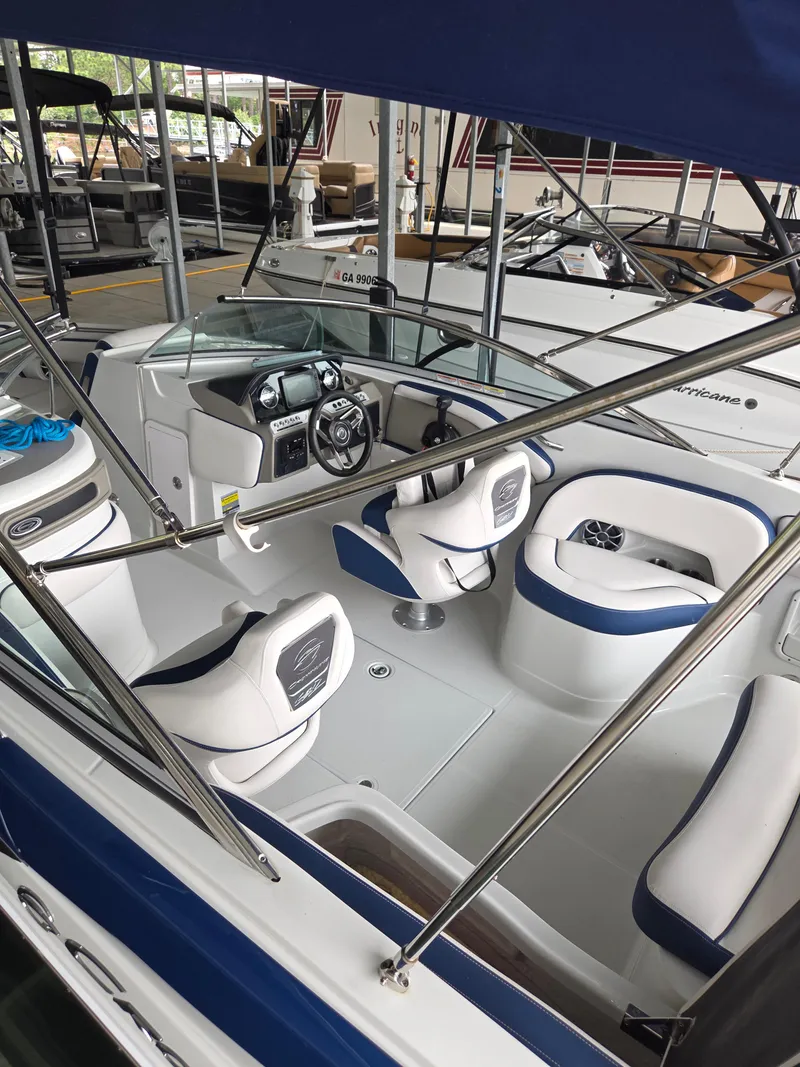Slide: The Image of 2023 Crownline 260 XSS boat interior with blue and white seating and modern dashboard. - 12