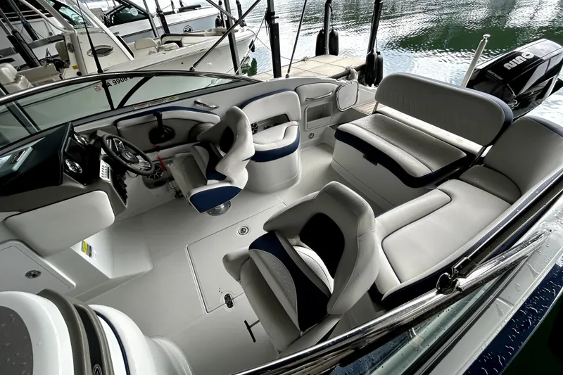 Slide: The Image of 2023 Crownline 260 XSS boat interior with modern seating and steering wheel. - 16