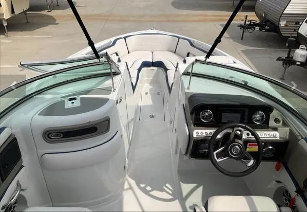 Slide: The Image of 2023 Crownline 260 XSS boat interior with modern dashboard and seating. - 2