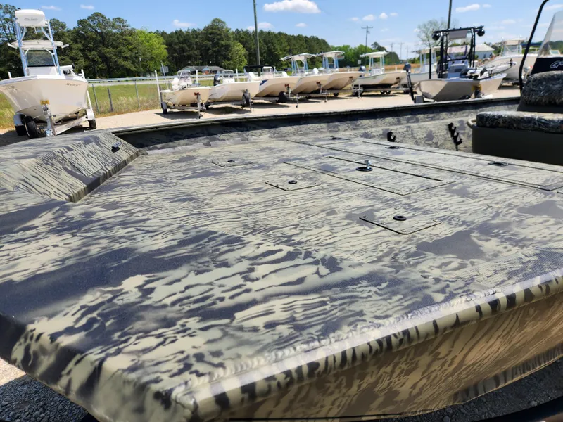 Slide: The Image of 2024 Tracker Grizzly 2072 CC boat with camouflage design, displayed outdoors. - 10
