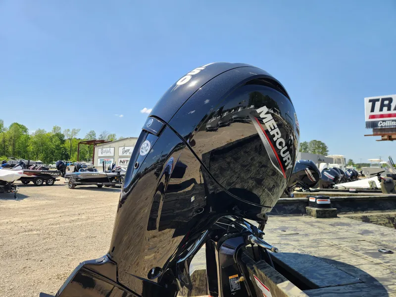 Slide: The Image of 2024 Tracker Grizzly 2072 CC with Mercury outboard motor in a boat dealership. - 3