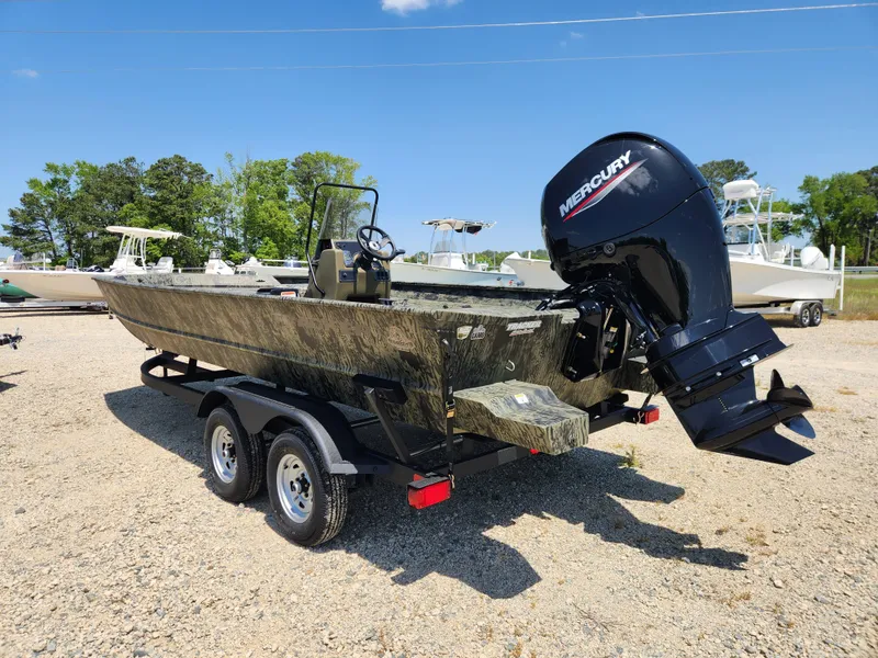 Slide: The Image of 2024 Tracker Grizzly 2072 CC boat with Mercury engine on a trailer. - 4