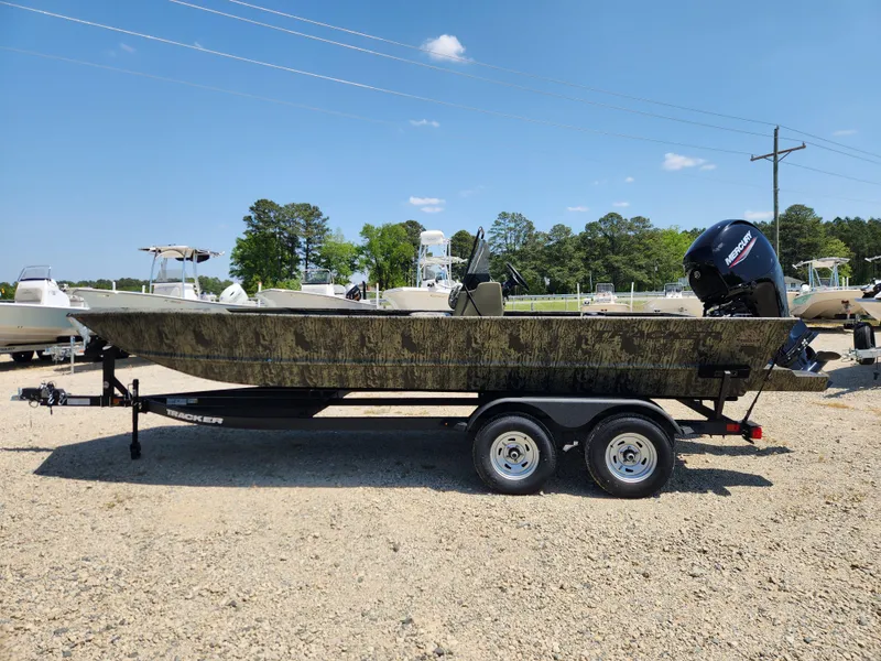 Slide: The Image of 2024 Tracker Grizzly 2072 CC boat on a trailer, parked outdoors. - 5