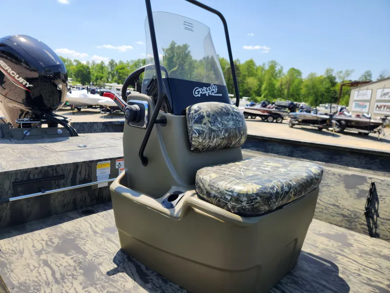 Slide: The Image of 2024 Tracker Grizzly 2072 CC boat with camo seating and steering console. - 7