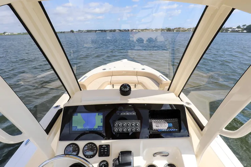Slide: The Image of 2023 Scout 231 XSB boat dashboard with navigation system on open water. - 15