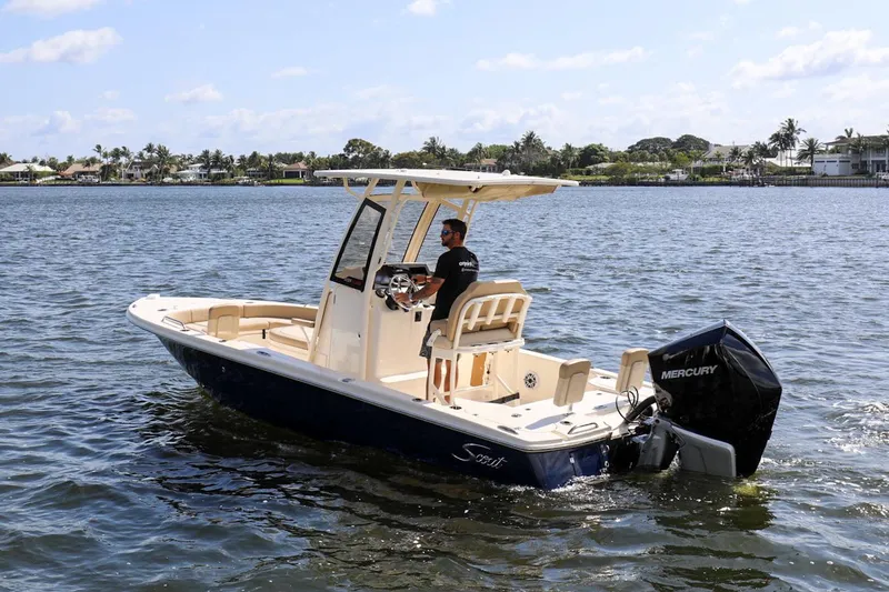 Slide: The Image of 2023 Scout 231 XSB boat cruising on a sunny day with a Mercury engine. - 23