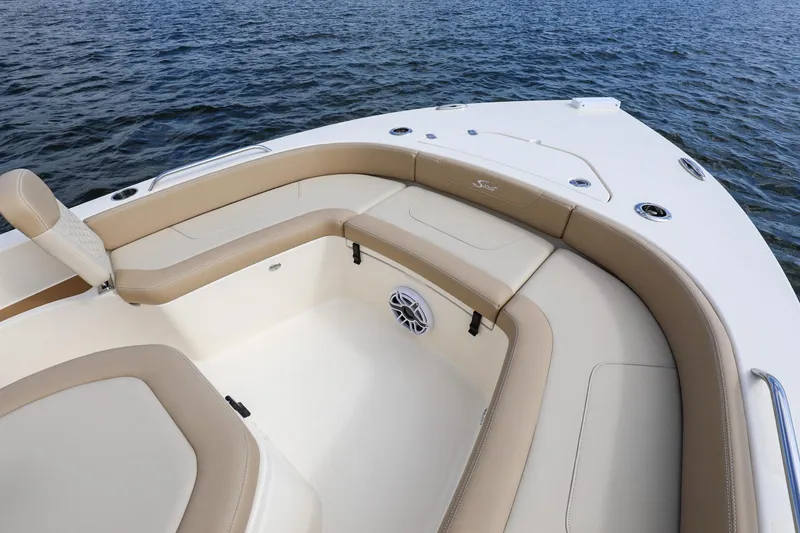 Slide: The Image of 2023 Scout 231 XSB boat interior with beige seating, on calm water. - 3