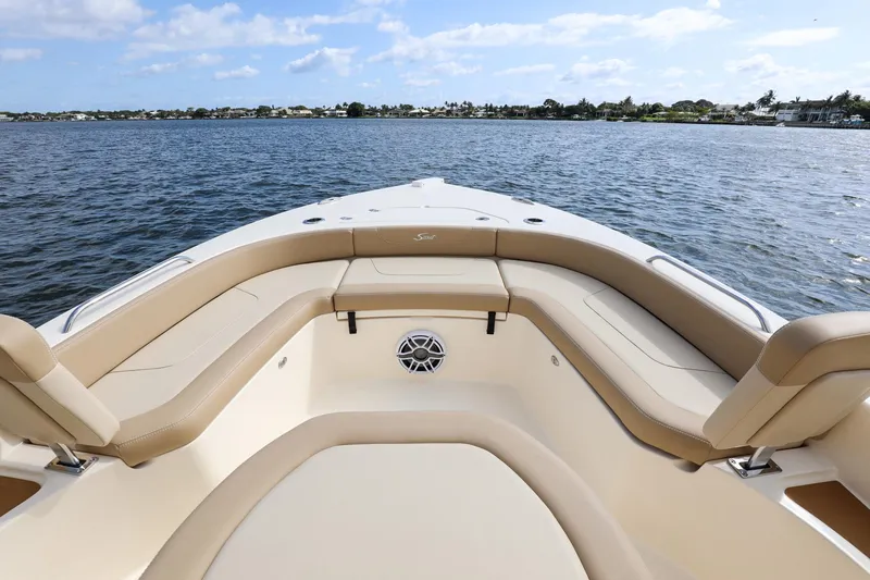 Slide: The Image of 2023 Scout 231 XSB boat interior with tan seating, on calm water. - 4