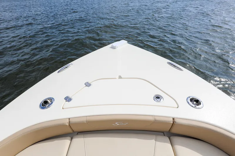 Slide: The Image of 2023 Scout 231 XSB boat bow on water, featuring sleek design and beige seating. - 5